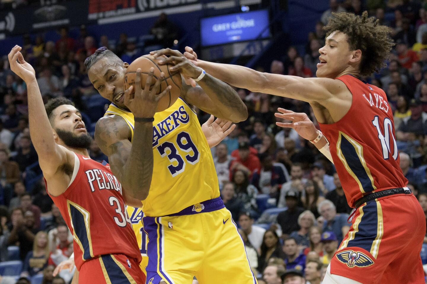 Lakers center Dwight Howard (39) battles for a rebound against Pelicans center Jaxson Hayes (10) and guard Kenrich Williams (34) during a game Nov. 27 at Smoothie King Center.