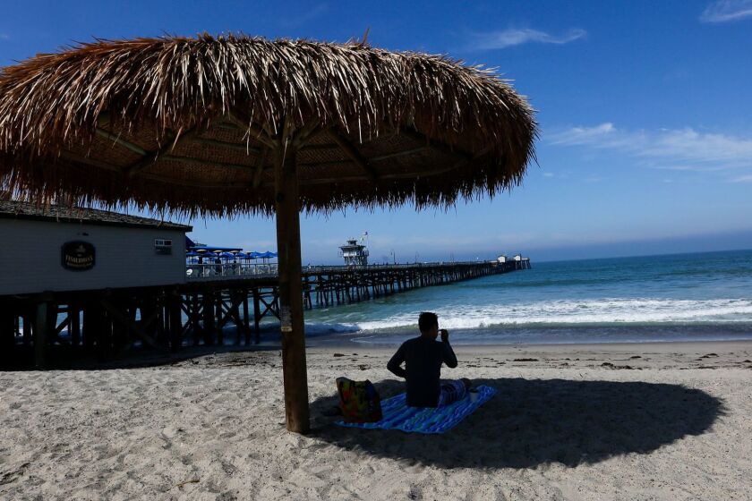 SAN CLEMENTE,CA, MAY 23, 2017: The warnings being given to surfers, swimmers and beachgoers at San Clemente aren't stopping people from enjoying the sun May 23, 2017. Monday, 20 young great white sharks were spotted basking in the waters between the San Clemente Pier and Capistrano Shores (Mark Boster / Los Angeles Times ).