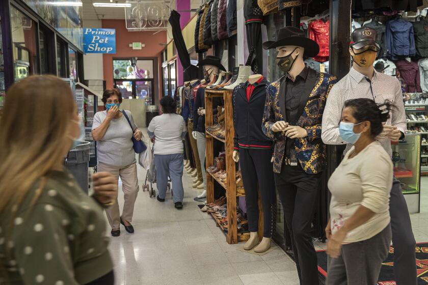 LYNWOOD, CA - NOVEMBER 30, 2020: People shop inside Plaza Mexico, a shopping mall in Lynwood. New coronavirus restrictions limit malls to 20% of capacity. (Mel Melcon / Los Angeles Times)