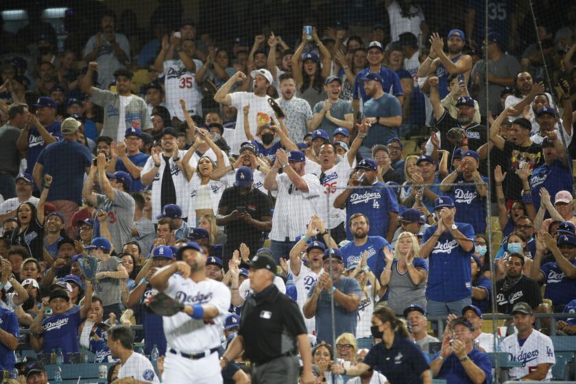 LOS ANGELES, CA - JUNE 15, 2021: Dodger fans cheer as Los Angeles Dodgers first baseman Albert Pujols (55) makes a catch to end the inning against the Phillies on reopening night at Dodger Stadium on June 15, 2021 in Los Angeles, California.(Gina Ferazzi / Los Angeles Times)