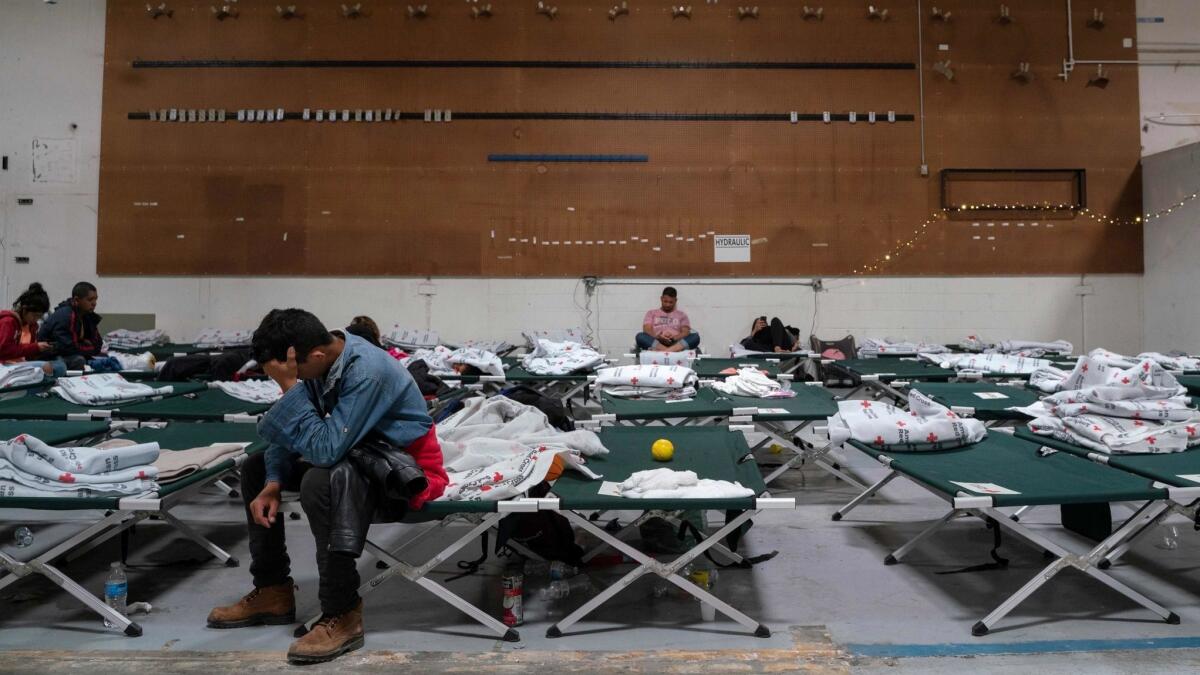 Migrants sit on cots in the Casa del Refugiado, or The House of Refugee, in El Paso, Texas on April 24.