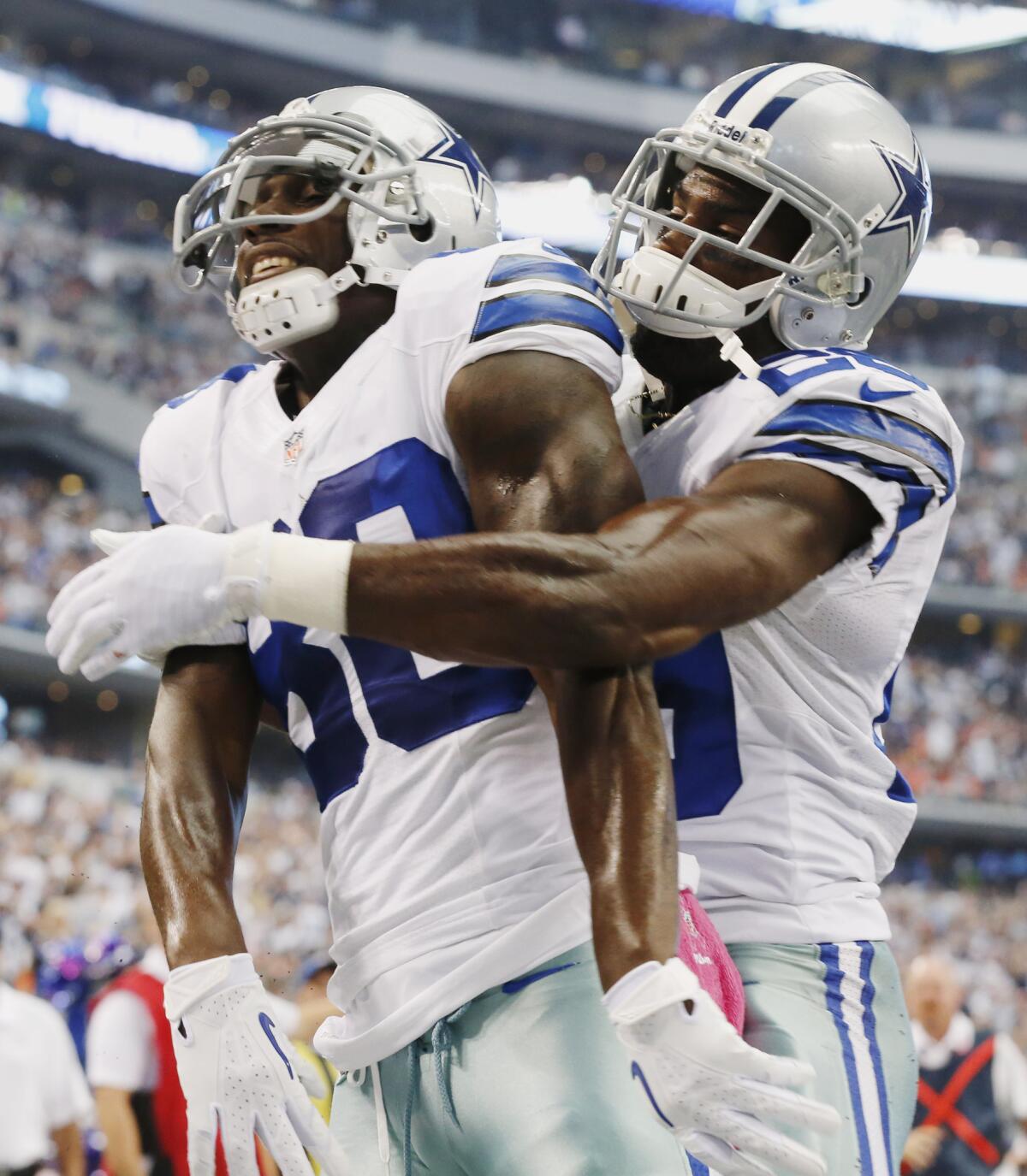 Dallas wide receiver Dez Bryant is congratulated by teammate DeMarco Murray after scoring a touchdown against the Denver Broncos in October 2013.