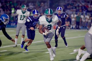 Darrell Stanley runs for a first down in Granada Hills’ 26-10 victory over Palisades in the 16th Charter Bowl game.