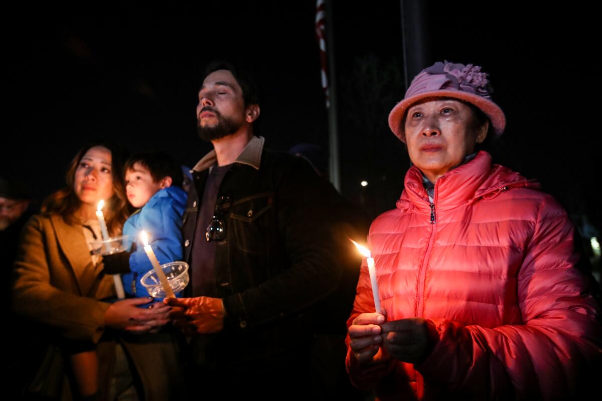 Mourners take part in a vigil for the victims of a mass shooting at the Star Dance Studio in Monterey Park.
