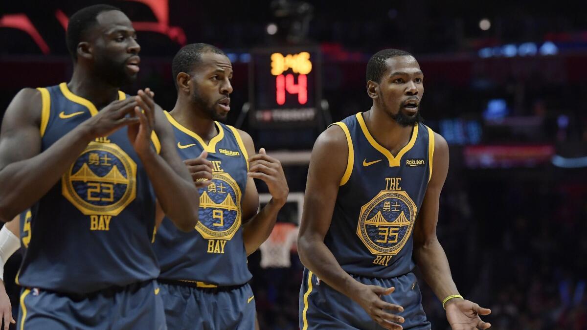 Golden State Warriors forward Kevin Durant, right, reacts as he fouls out of the game against the Clippers.