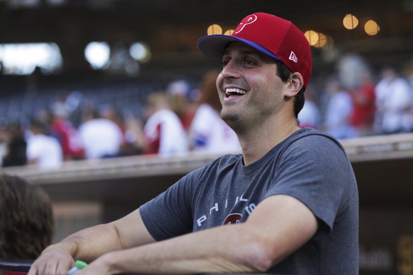 Philadelphia Phillies relief pitcher Mark Appel smiles in the dugout before the team's baseball game against the San Diego Padres, Saturday, June 25, 2022, in San Diego. Appel, the 2013 No. 1 overall draft pick, received his first major league call-up Saturday at the age of 30. (AP Photo/Derrick Tuskan)