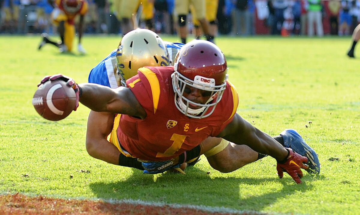 USC receiver Darreus Rogers reaches for the end zone as he is tackled by UCLA defensive back Nate Meadors on a 20-yard touchdown reception in the second half.