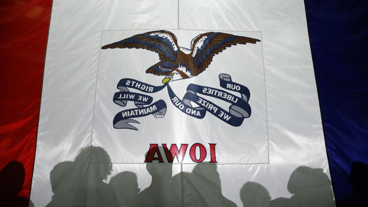 Attendees' shadows are cast on the Iowa flag at a town hall for Florida Sen. Marco Rubio in West Des Moines on Tuesday.