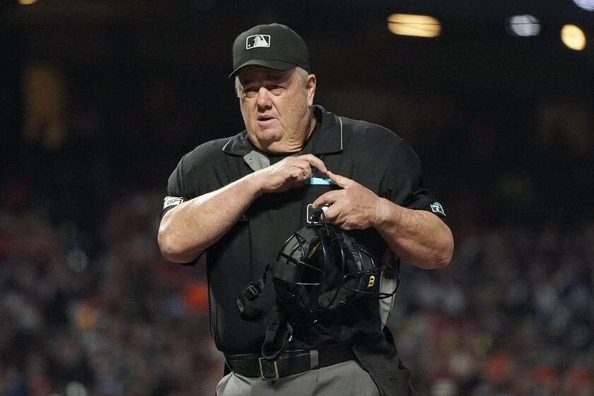 FILE - Umpire Joe West works a baseball game between the San Francisco Giants and the San Diego Padres in San Francisco, on Oct. 1, 2021. West has made it official, retiring from Major League Baseball after umpiring a record 5,460 regular-season games, MLB announced Friday, Feb. 4, 2022. (AP Photo/Jeff Chiu, File)