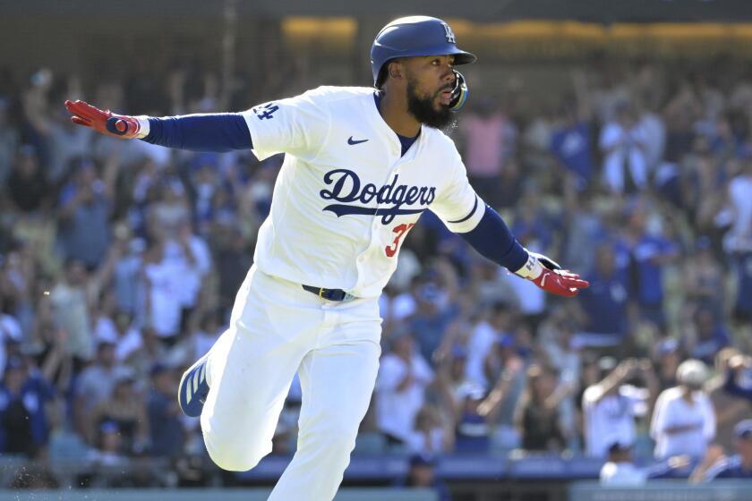 Los Angeles Dodgers' Teoscar Hernandez runs to first as he celebrates hitting a walk-off single to score Enrique Hernández in the tenth inning during a baseball game against the Pittsburgh Pirates Sunday, Aug. 11, 2024, in Los Angeles. (AP Photo/Jayne-Kamin-Oncea)