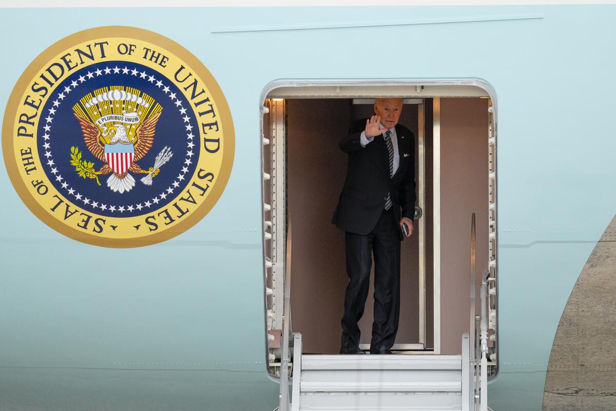 President Biden waves from jet's doorway 