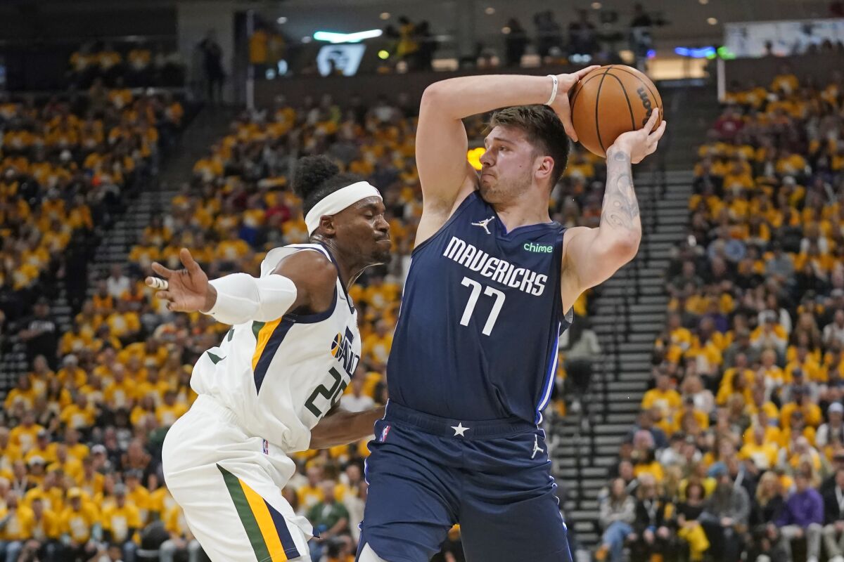 The Jazz's Danuel House Jr. defends the Mavericks' Luka Doncic on April 23, 2022.