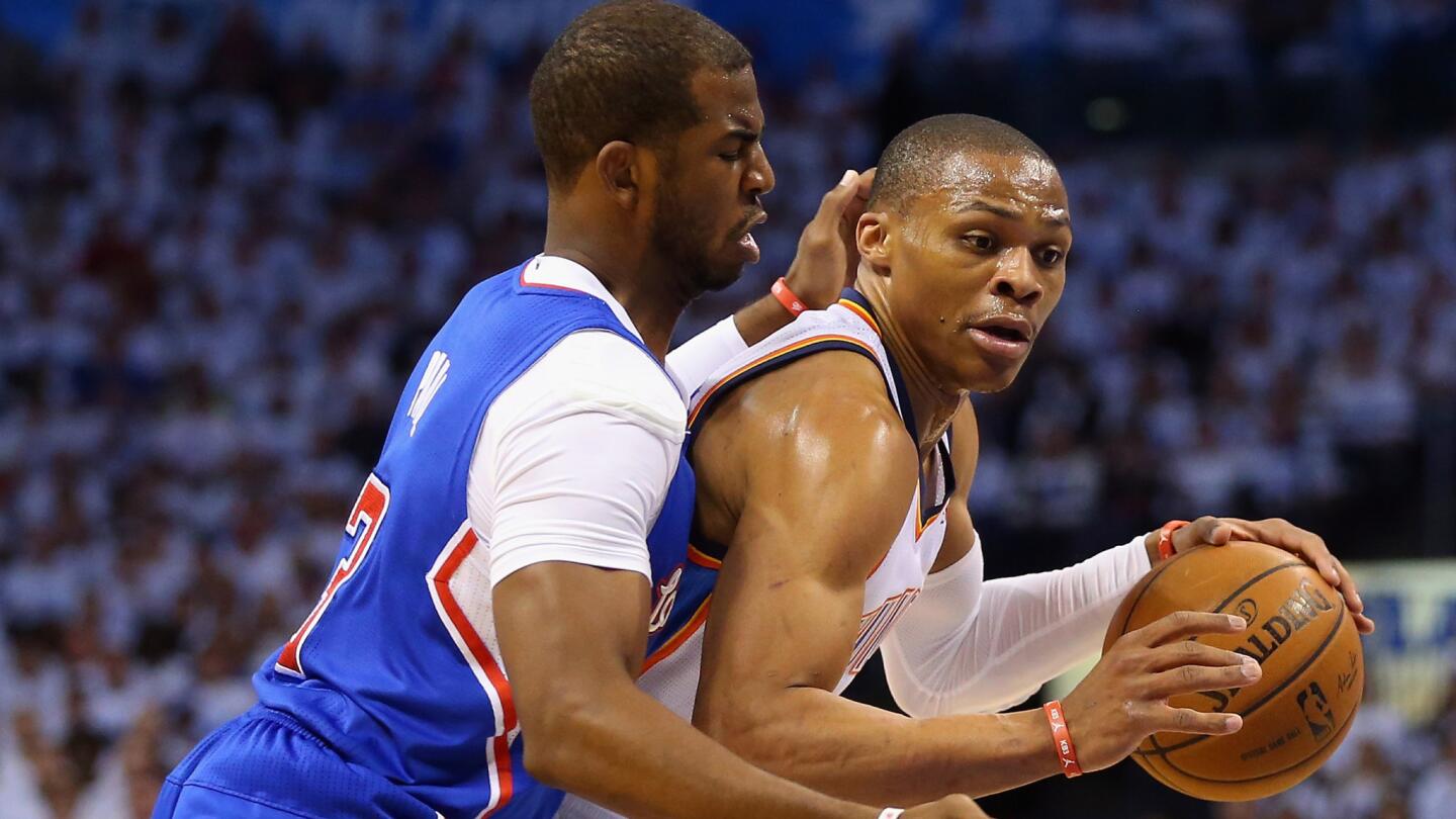 Clippers point guard Chris Paul, left, defends against Oklahoma City Thunder point guard Russell Westbrook during the first quarter of Game 5 of the Western Conference semifinals.
