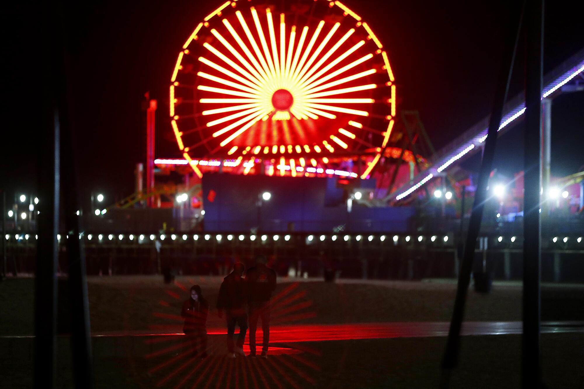 Youths violate a beach closure in Santa Monica as the coronavirus stay-at-home order continues in Southern California. 