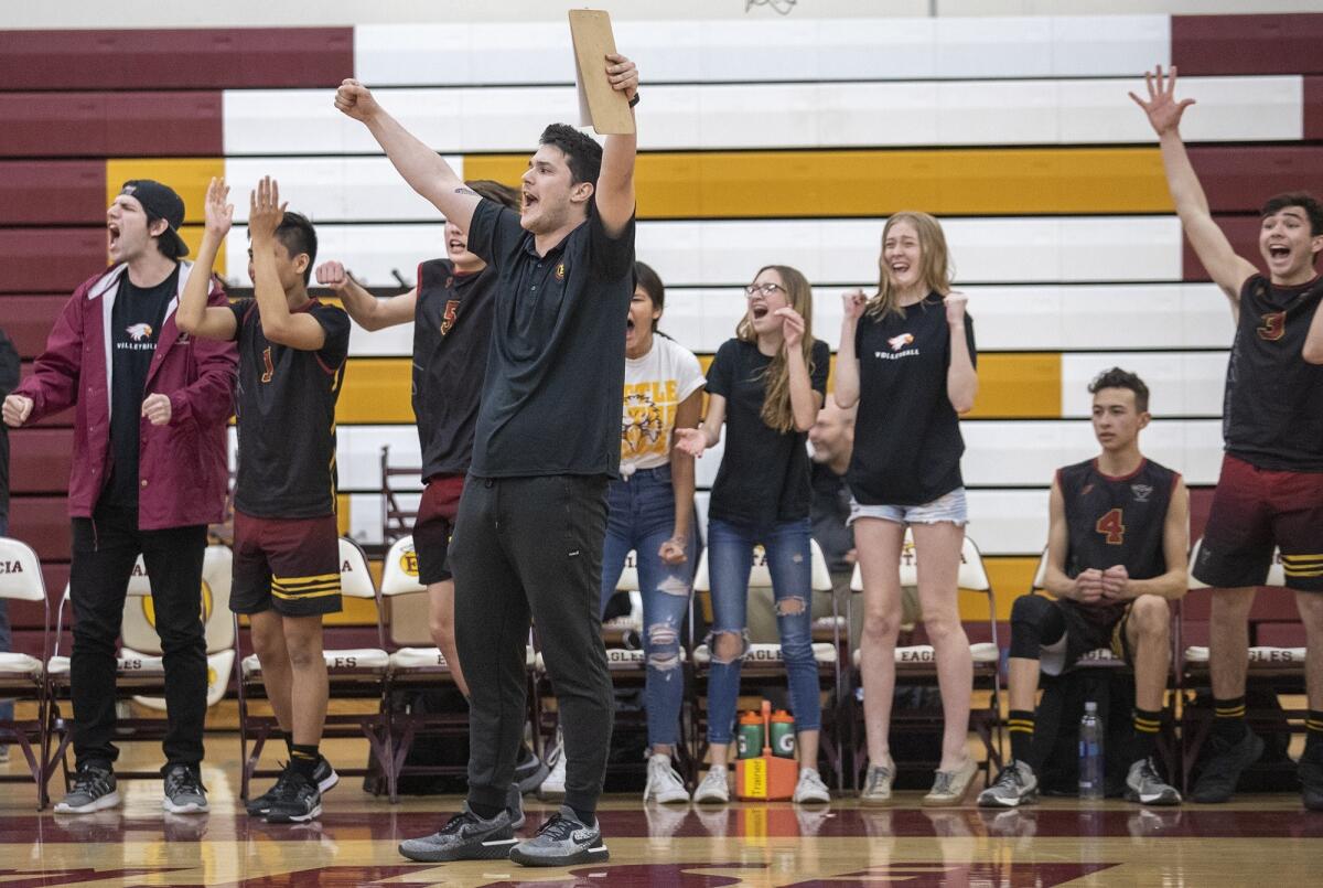 Estancia High coach Alejandro De Mendoza celebrates a point in the fifth set against Costa Mesa during an Orange Coast League match on Thursday.