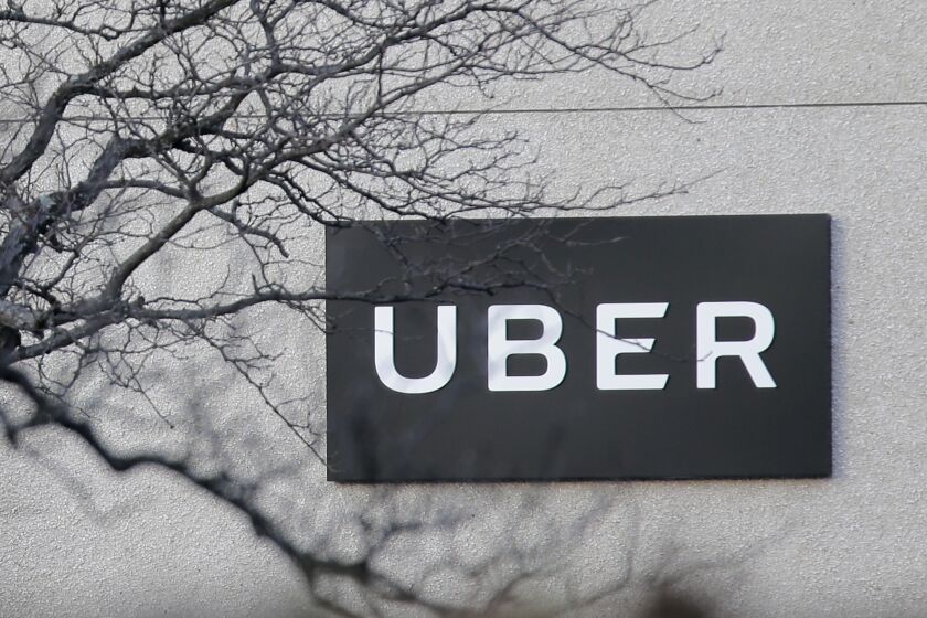 FILE - In this Nov. 15, 2019, file photo an Uber office is seen in Secaucus, N.J. Just as the coronavirus outbreak has boxed in society, it’s also squeezed high-flying tech companies reliant on people’s freedom to move around and get together. Uber has tried to reassure investors that it has enough cash to weather the fallout from the global pandemic and is turning to deliveries to make up for lost income after ride-hailing screeched to a halt. (AP Photo/Seth Wenig, File)