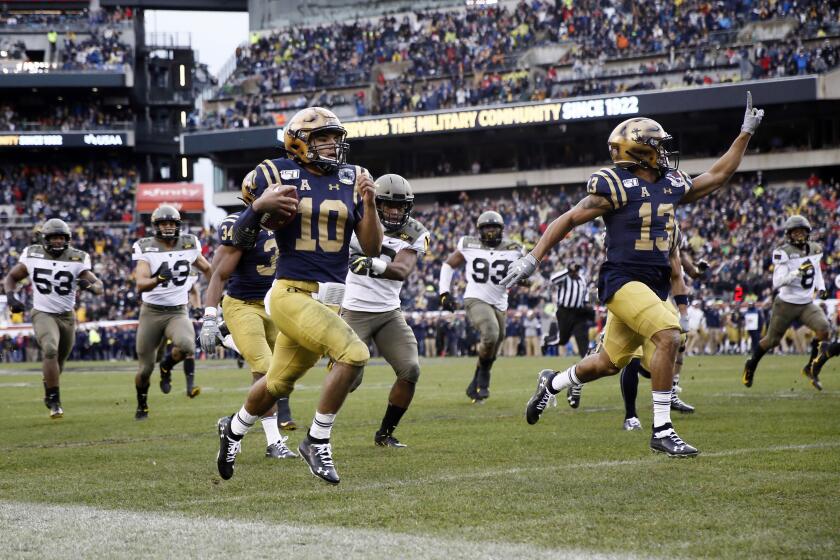 Navy's Malcolm Perry (10) runs for touchdown during the first half of an NCAA college football game against Army, Saturday, Dec. 14, 2019, in Philadelphia. (AP Photo/Matt Slocum)