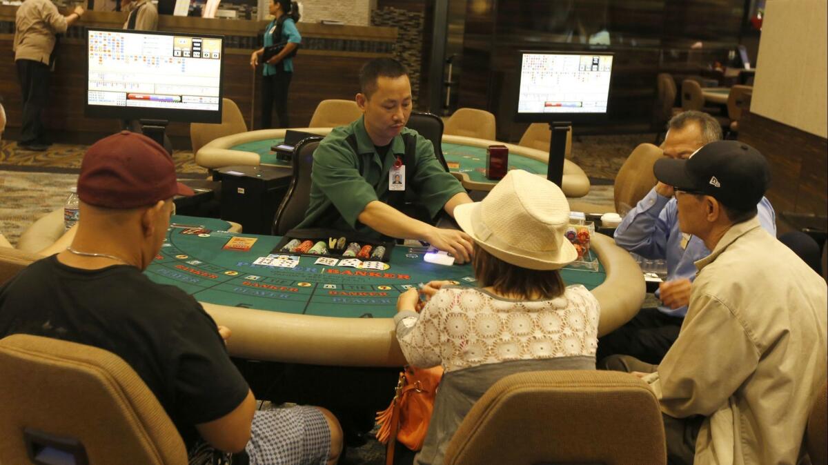 Card players and dealer at a table at The Gardens Casino in Hawaiian Gardens.