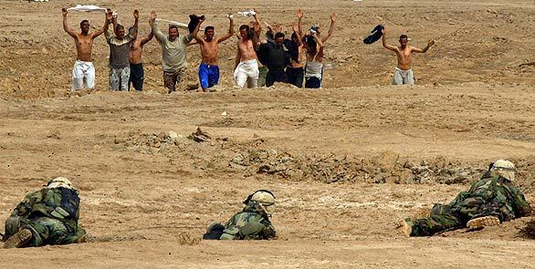 Iraqi guerrilla fighters surrender to U.S. troops