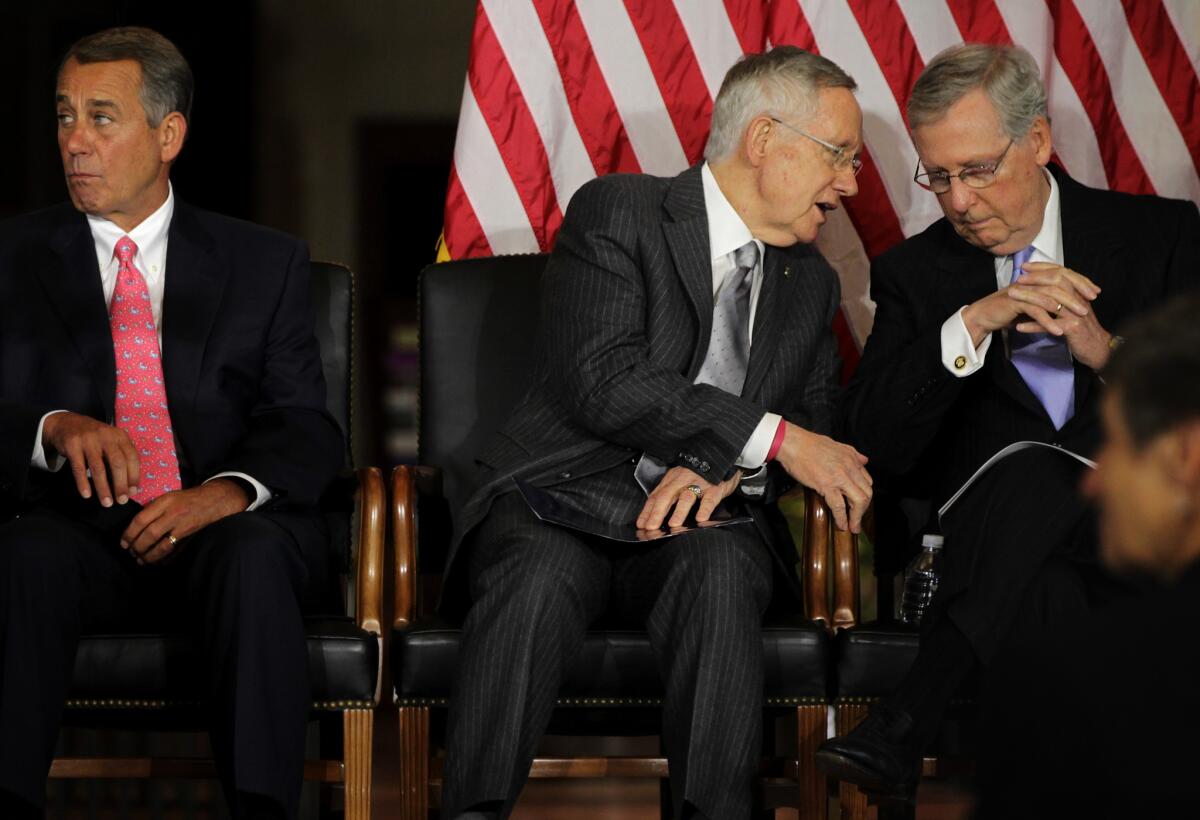 Senate Majority Leader Harry Reid (D-Nev.) talks to Senate Minority Leader Mitch McConnell (R-Ky.) during a Congressional Gold Medal presentation ceremony with House Speaker John A. Boehner (R-Ohio) at the Capitol Visitors Center.