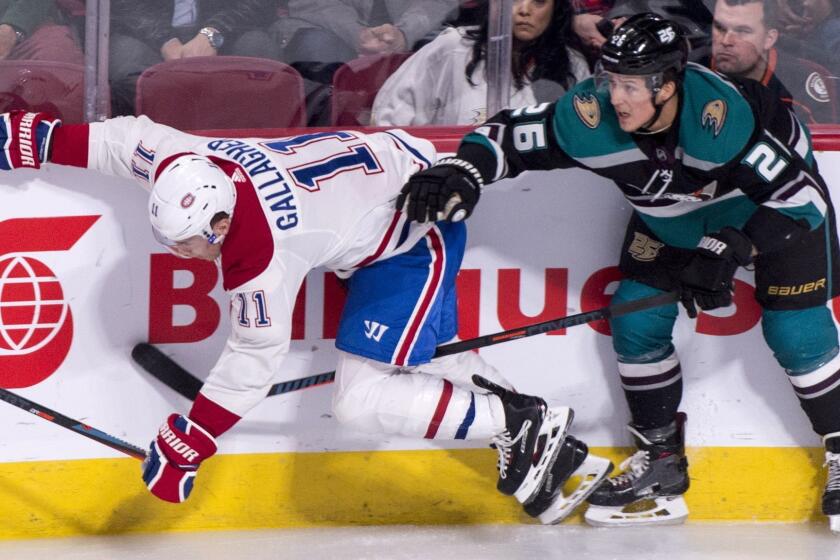 Montreal Canadiens' Brendan Gallagher takes a hit from Anaheim Ducks' Brandon Montour during the second period of an NHL hockey game, Tuesday, Feb. 5, 2019 in Montreal. (Paul Chiasson/The Canadian Press via AP)
