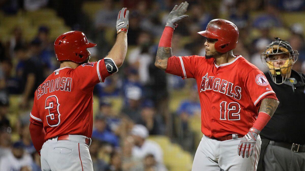 Angels' Martin Maldonado, right, celebrates his home run with Danny Espinosa during the ninth inning against the Dodgers on Monday.