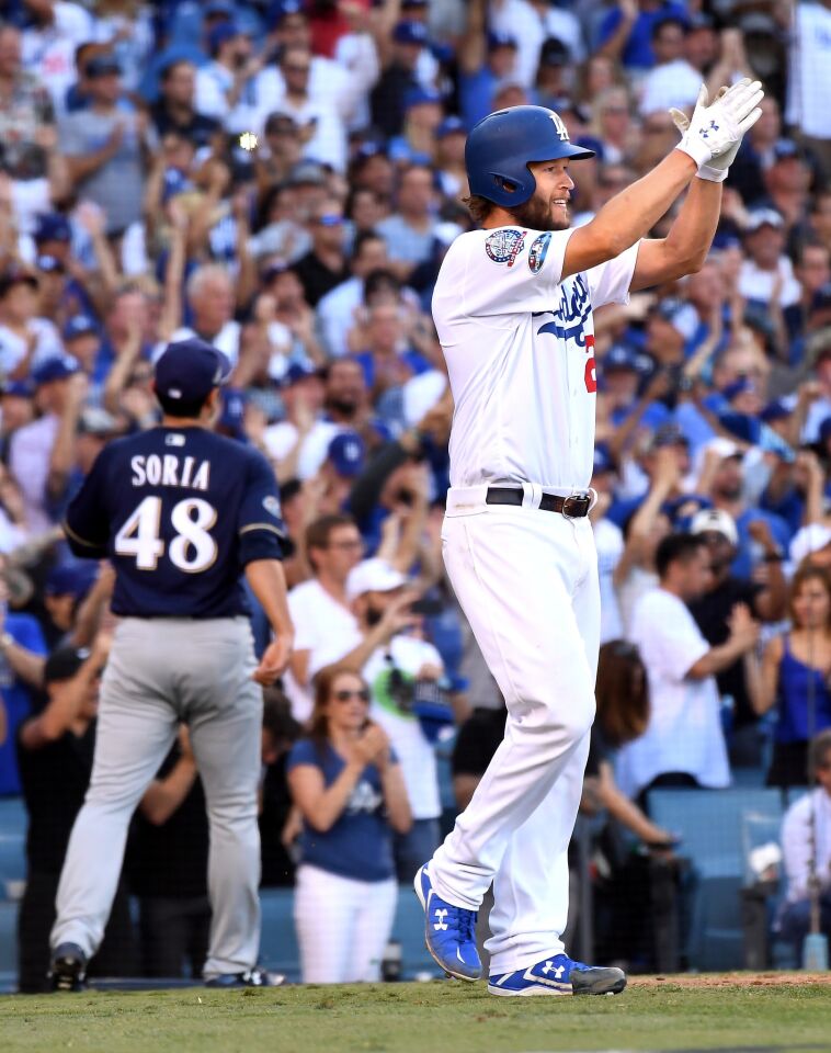 Dodgers Clayton Kershaw celebrates after scoring a run against the Brewers in the 7th inning.