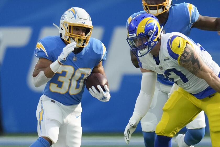 Los Angeles Chargers running back Austin Ekeler (30) carries the ball during the first half of an NFL football game.