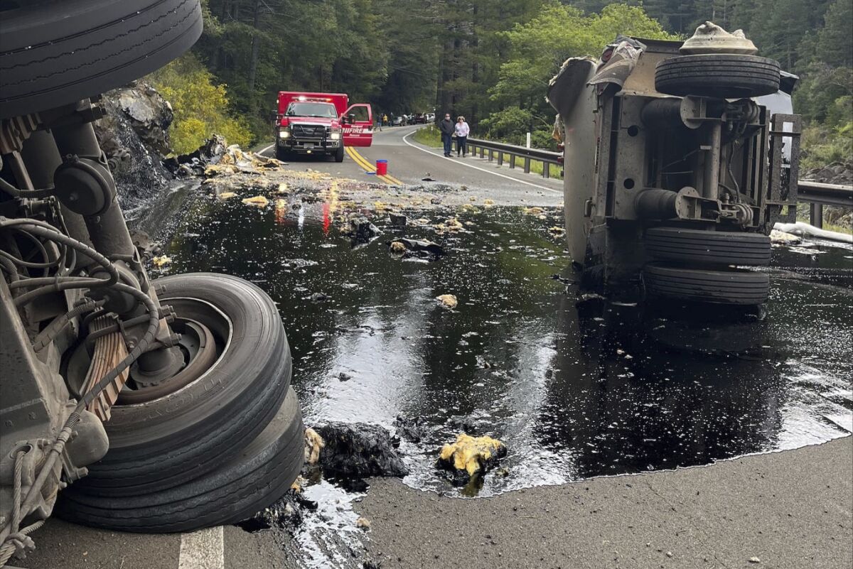 This Tuesday, April 29, 2022 photo released by the U.S. Forest Service - Six Rivers National Forest shows a semi-truck that had a damaged tire as it traveled on State Route 199 in Del Norte County near Gasquet, Calif. The truck crashed on a remote highway spilled 2,000 gallons of hot asphalt binder in a Northern California forest near Gasquet, Calif. The driver was arrested on suspicion of DUI. The trailer eventually overturned, spilling hot asphalt binder, which began seeping into the Smith River. Del Norte County Office of Emergency Services says there is no impact to water quality. (U.S. Forest Service via AP)