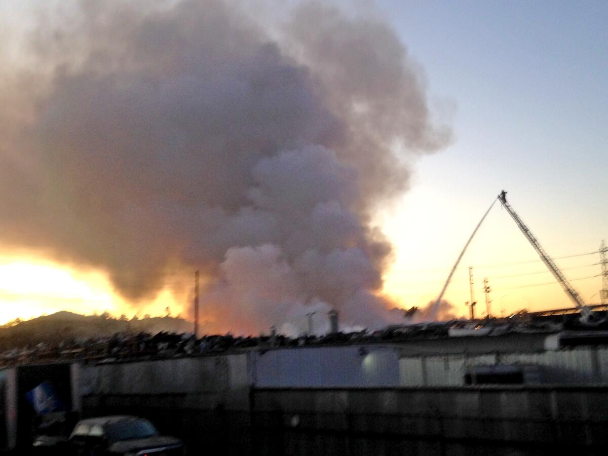 Firefighters battle a fire that broke out at a recycling facility near Glendale near the 134 and 5 freeways on Friday. Glendale firefighters are helping their Los Angeles counterparts battle the blaze.