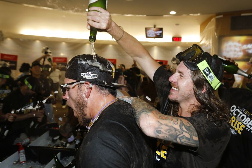 SAN DIEGO, CA - OCTOBER 2: San Diego Padres' Joe Musgrove and Mike Clevinger celebrate in the clubhouse after the team clinched a wildcard playoff spot at Petco Park on Sunday, October 2, 2022 in San Diego, CA. (K.C. Alfred / The San Diego Union-Tribune)