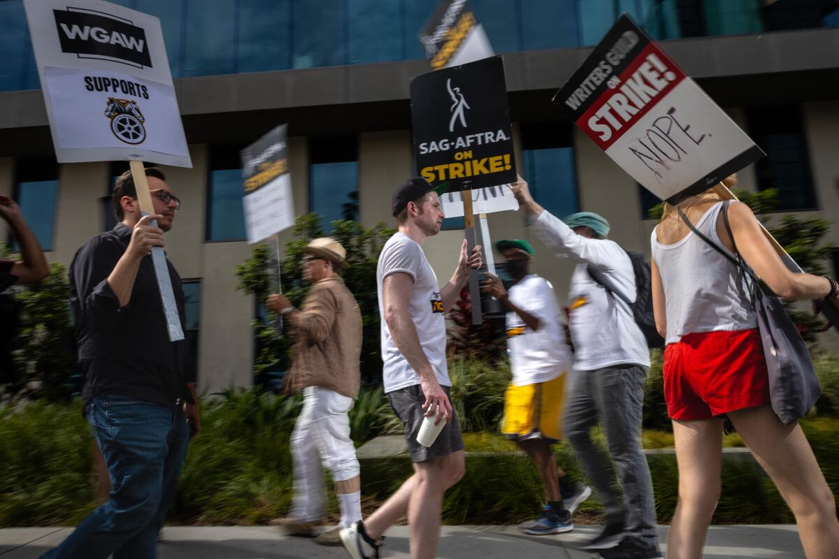 Members of the WGA and SAG-AFTRA unions picket in Hollywood.