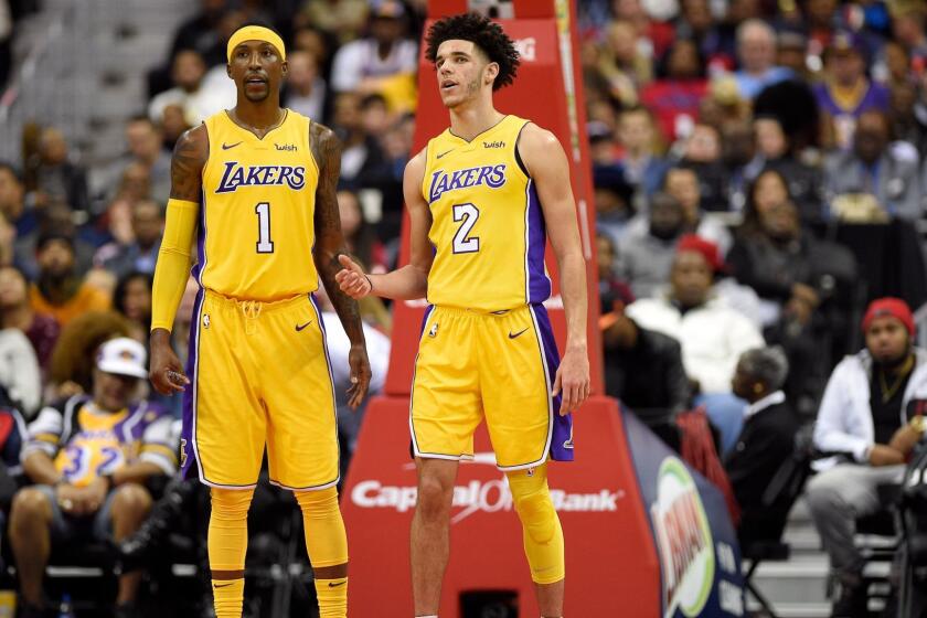 Los Angeles Lakers guard Lonzo Ball (2) talks with guard Kentavious Caldwell-Pope (1) during the first half of an NBA basketball game against the Washington Wizards, Thursday, Nov. 9, 2017, in Washington. (AP Photo/Nick Wass)