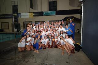 Members of the UCLA women's water polo team celebrate.