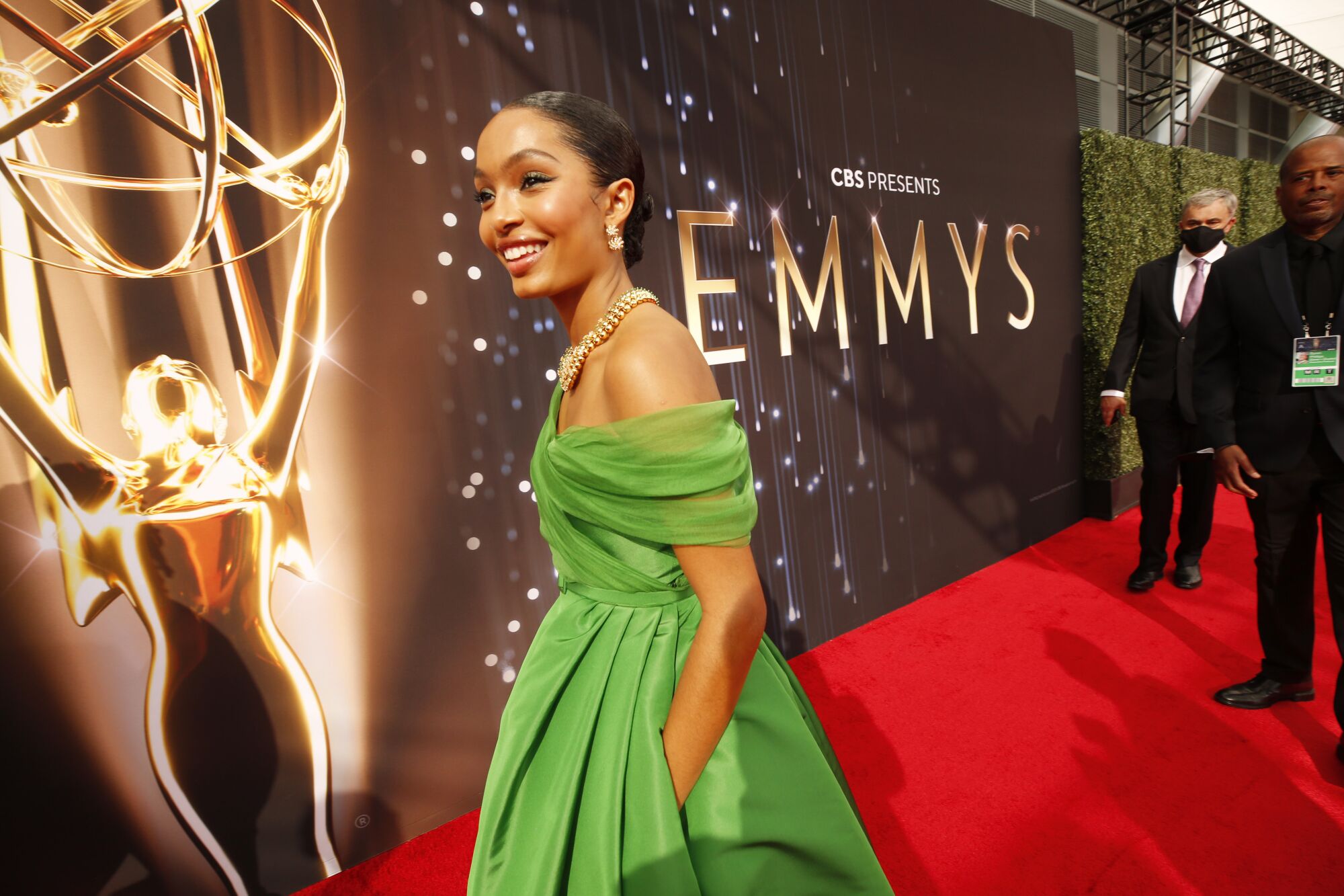 Yara Shahidi arrives on the red carpet in a green gown.