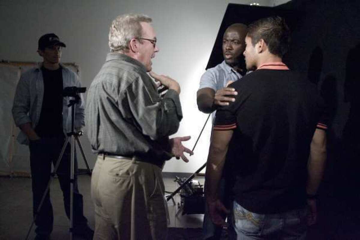 Mentor Fred Bailey, from second left, directs his students, Joe Fidler, from far left, Alex Sonpon and Steve Angeles at International Academy of Film and Television in Burbank on Thursday. The school opened on April 20, 2012 and have schools in Miami and Cebu, Philippines. They will also be opening a school in Hong Kong.