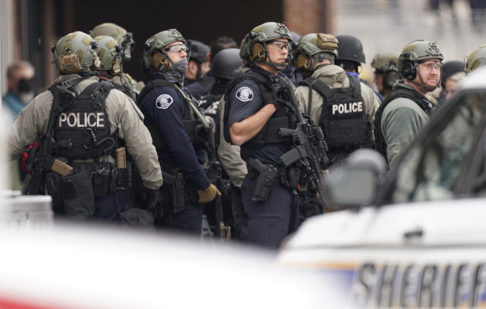 Police work on the scene outside a King Soopers grocery store where a shooting took place Monday