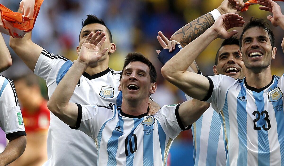 Argentina forward Lionel Messi (10) celebrates with teammates after beating Belgium, 1-0, in a World Cup quarterfinal game on Saturday at Mane Garrincha National Stadium in Brasilia.