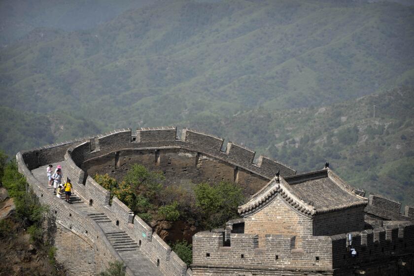 Visitors walk on a hot day along a stretch of the Jinshanling section of the Great Wall of China, north of Beijing in northern China's Hebei Province, Wednesday, July 5, 2023. (AP Photo/Mark Schiefelbein)