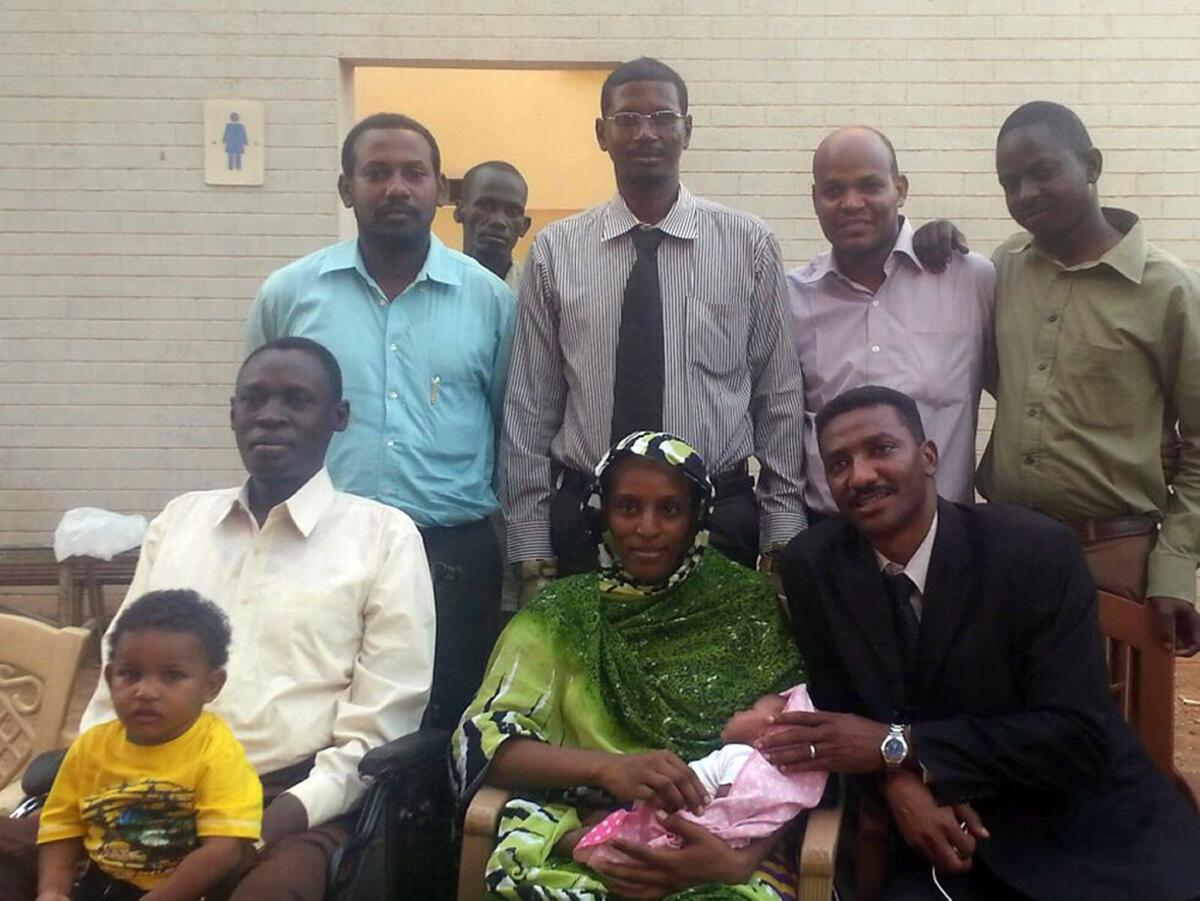 Meriam Ibrahim with her husband, children and legal team at an undisclosed location in Khartoum on June 23.