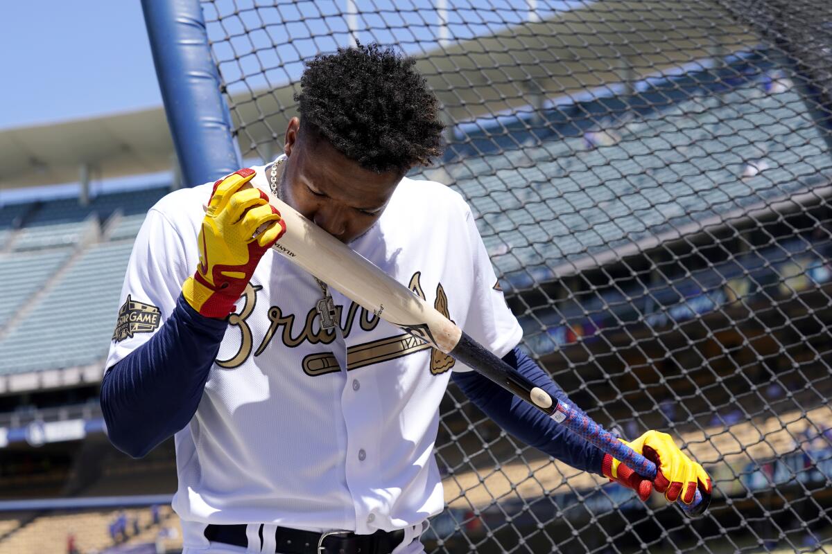 Atlanta Braves star Ronald Acuna Jr. kisses his bat during batting practice before the MLB All-Star Game on Tuesday.