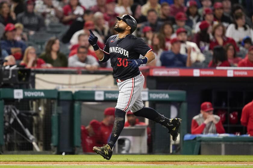 Minnesota Twins' Carlos Santana gestures while running the bases after hitting a three-run home run against the Los Angeles Angels during the fourth inning of a baseball game Saturday, April 27, 2024, in Anaheim, Calif. (AP Photo/Ryan Sun)