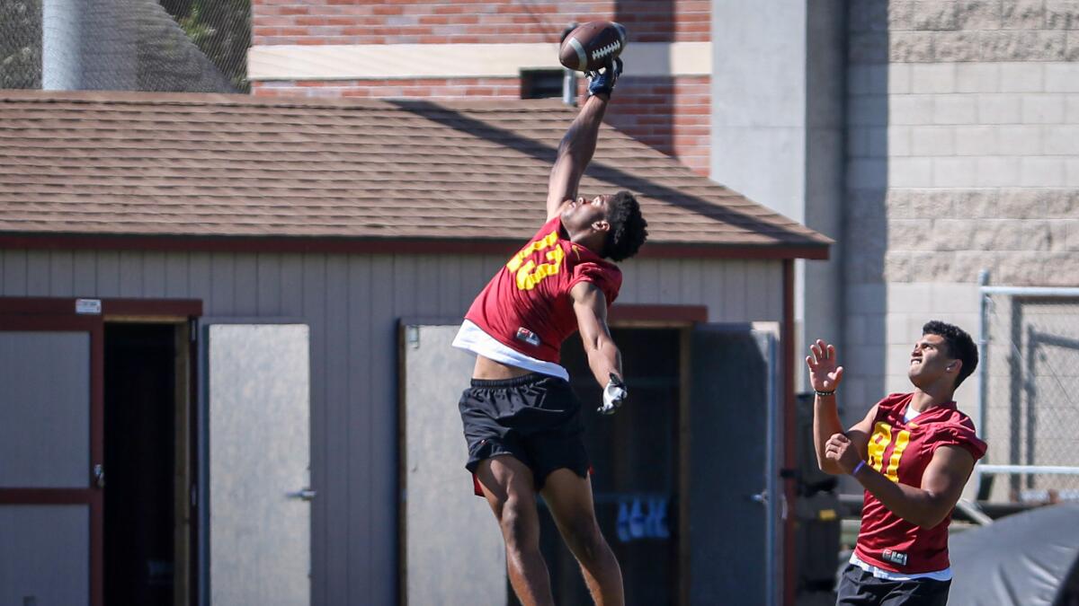 USC freshman Munir McClain leaps up for a pass on the sideline Monday.