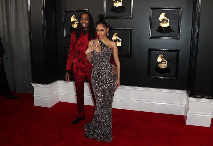 Rappers Quavo in a red suit and Saweetie in a sparkling gown at the 2020 Grammys
