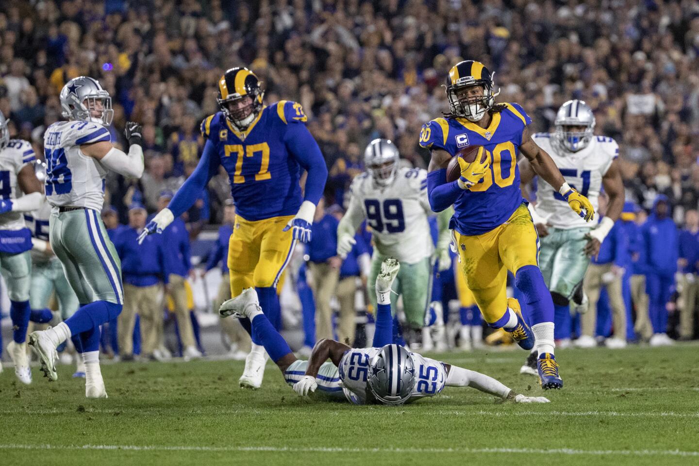 Rams running back Todd Gurley (30) breaks through the tackle attempt of Cowboys free safety Xavier Woods (25) to score on a 35-yard run during the second quarter.