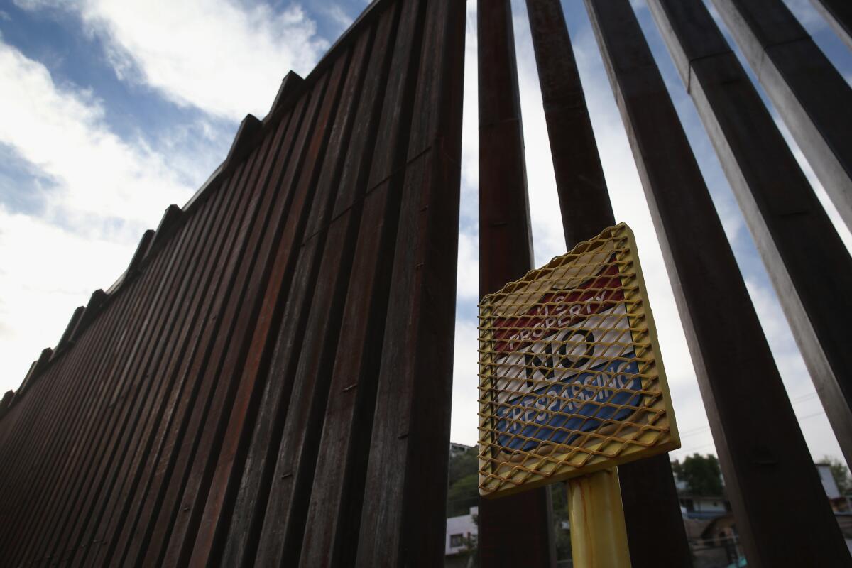 A no trespassing sign appears is shown at a U.S.-Mexico border fence in April in Nogales, Ariz.