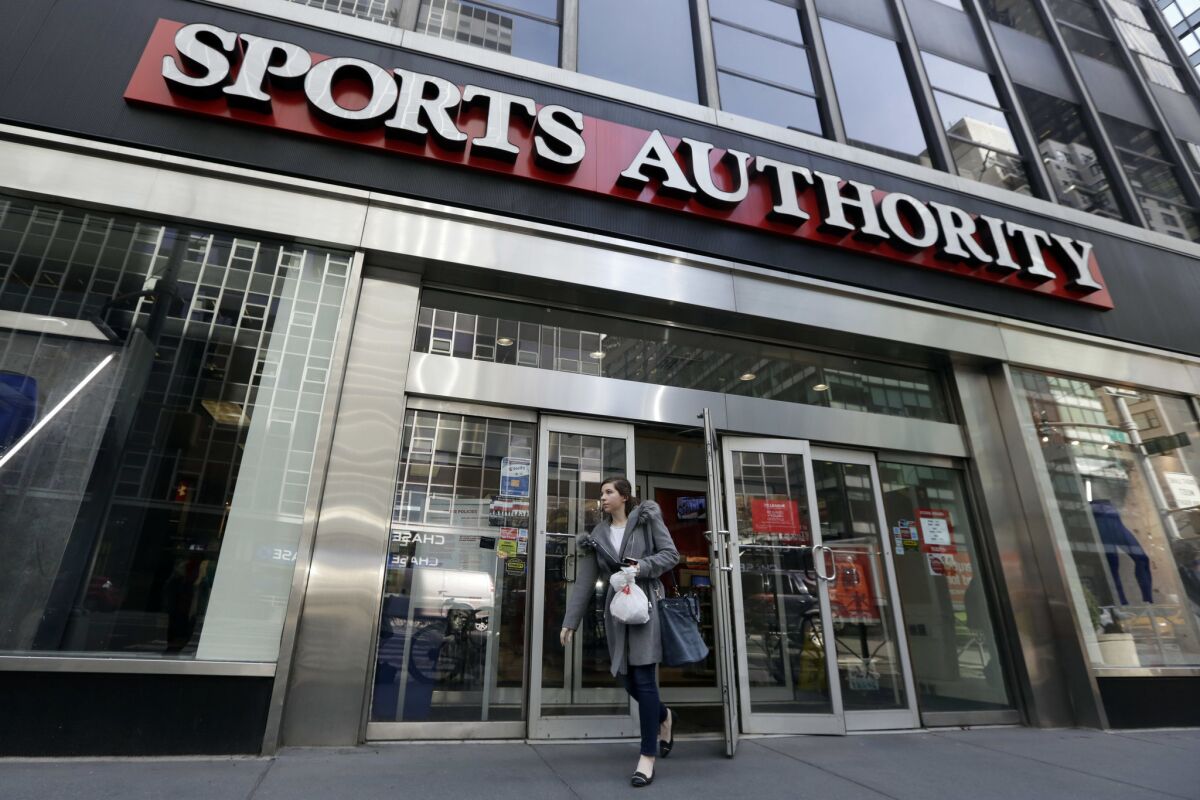 A woman leaves a Sports Authority store in New York on Wednesday.