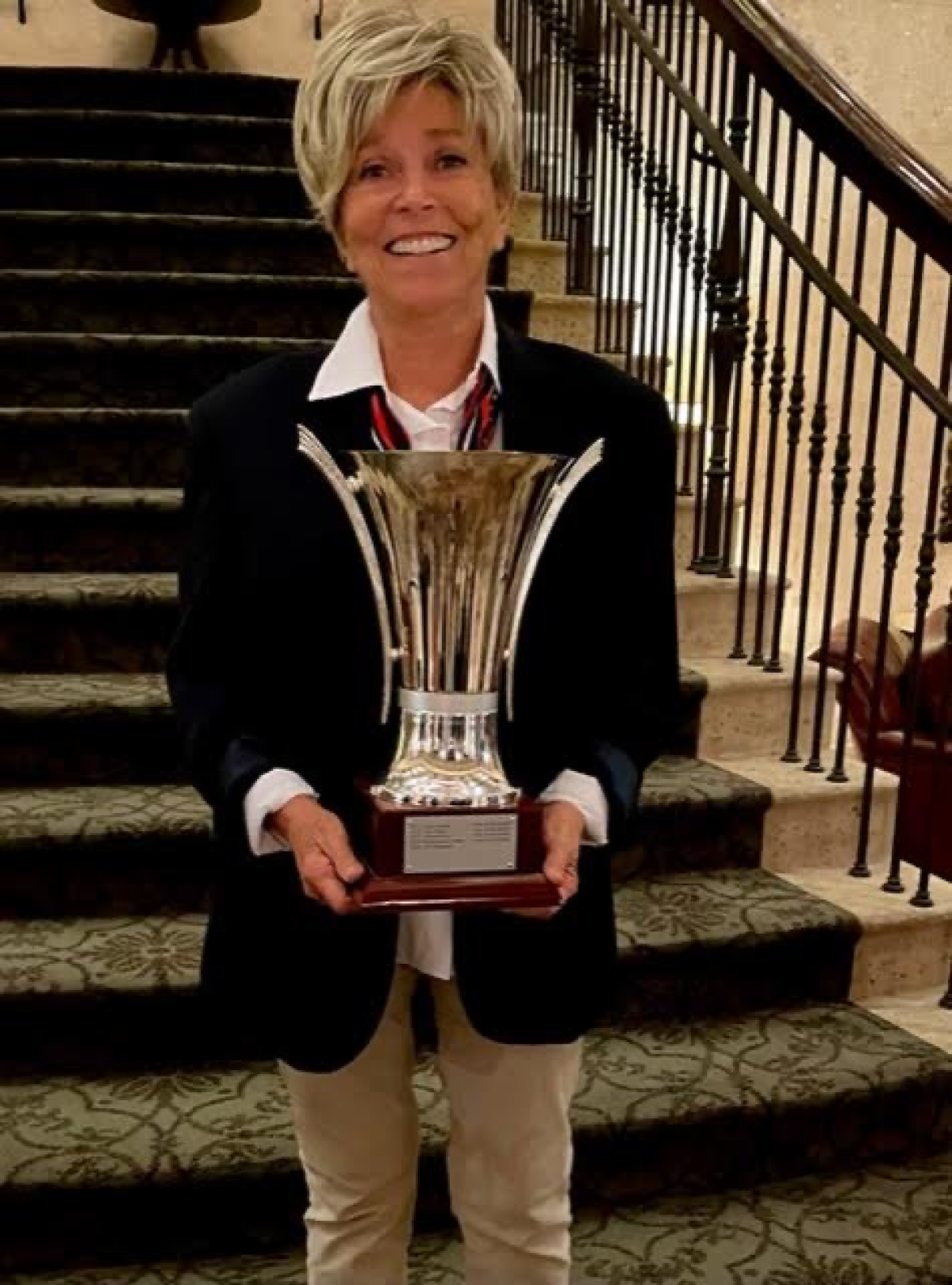 Rancho Santa Fe resident Linda Port displays the trophy her team won in the Vision Cup at TPC Sawgrass in Florida.