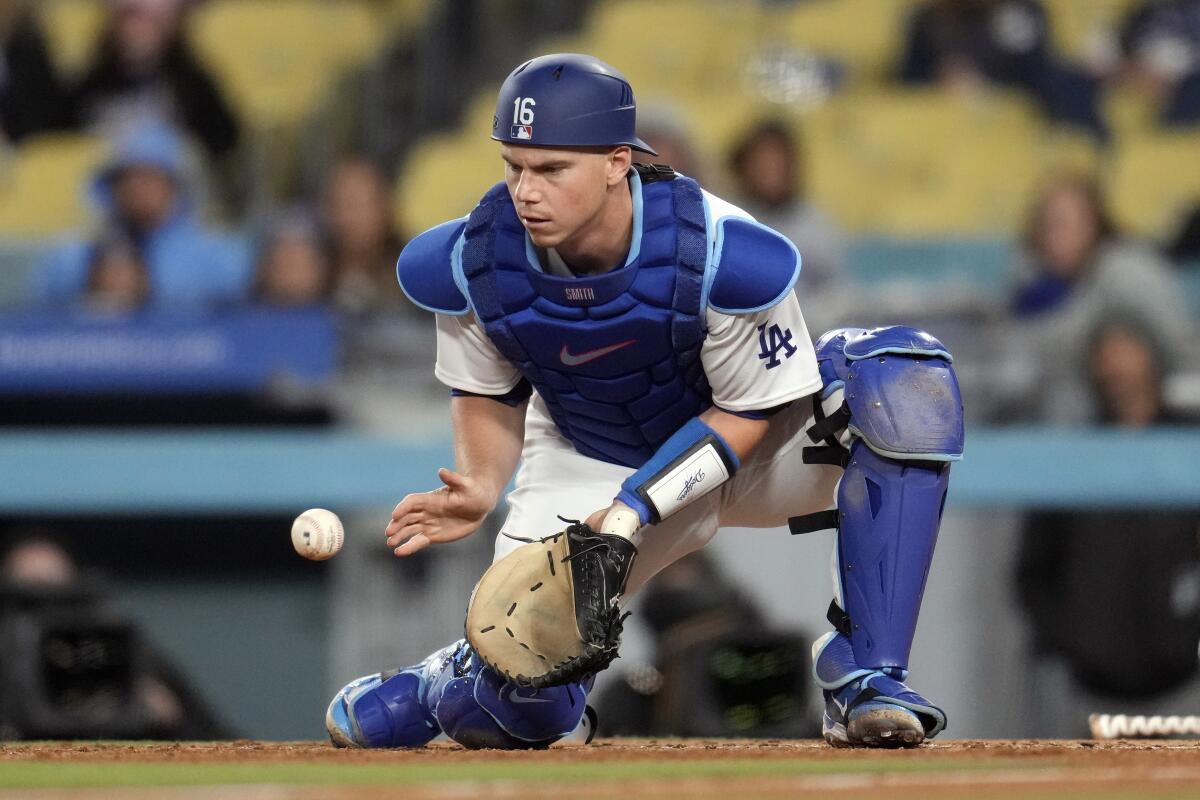 Dodgers catcher Will Smith gathers a throw from the outfield against the Colorado Rockies on April 4.