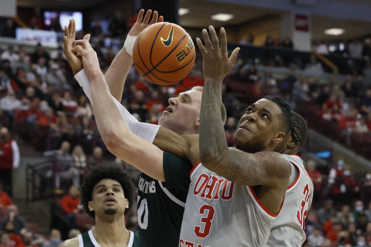 Michigan State's Joey Hauser, left, and Ohio State's Eugene Brown vie for a rebound during the second half of an NCAA college basketball game Thursday, March 3, 2022, in Columbus, Ohio. (AP Photo/Jay LaPrete)